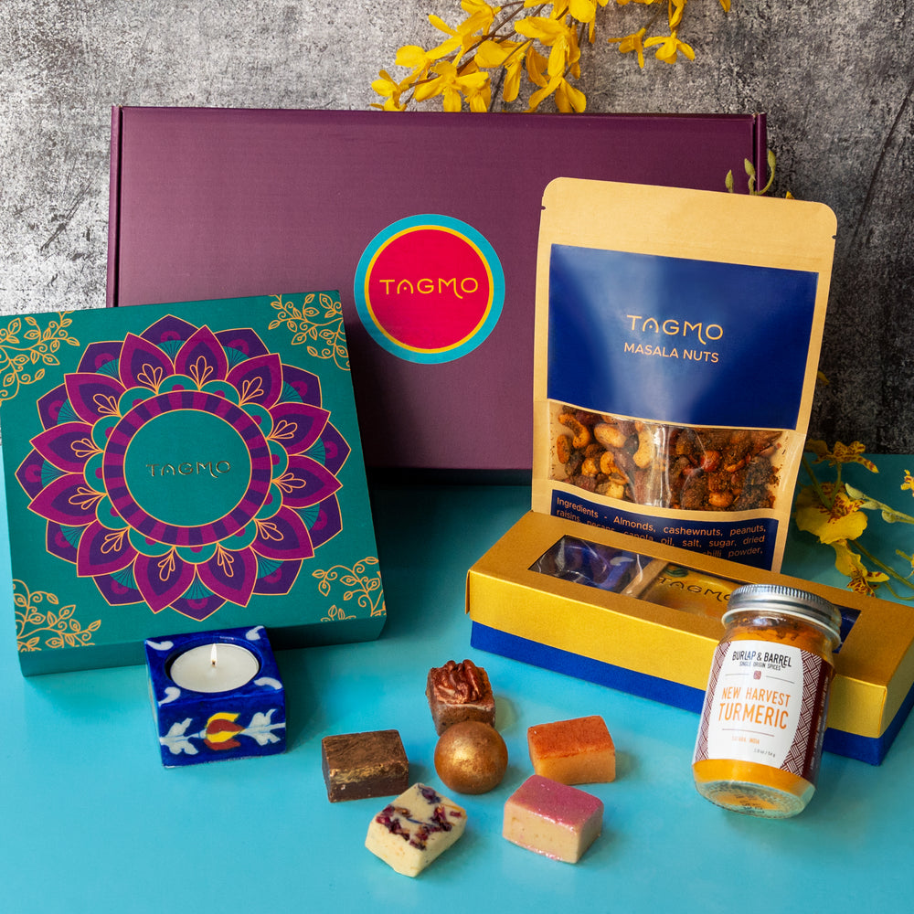 
                      
                        Devi Collection Shopify product: Assortment of traditional Indian sweets, snacks, and décor items including katli, ladoos, diyas, masala nuts, and more, showcased in an elegant gift box design.
                      
                    